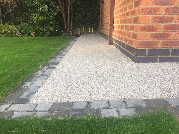 Resin pathway in grey to side of garage